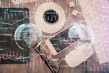 Multi exposure of forex graph hologram over desktop with phone. Top view. Mobile trade platform...