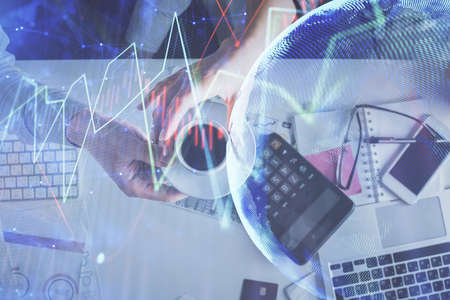 Double exposure of man and woman working together and financial chart hologram drawing. market...