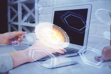 Double exposure of woman hands typing on computer and crypto market theme hologram drawing....