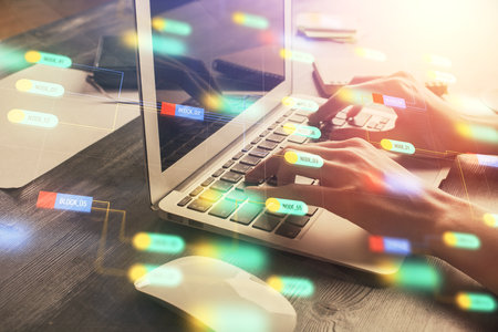 Double exposure of woman hands working on computer and data theme hologram drawing. Tech concept.
