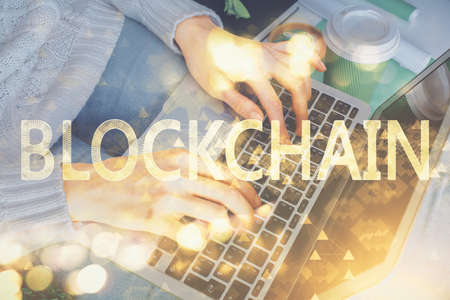 Double exposure of woman hands typing on computer and crypto market theme hologram drawing....