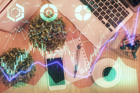 Multi exposure of financial chart hologram over desktop with phone. Top view. Mobile trade platform...