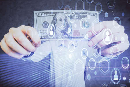 Multi exposure of social network theme drawing hologram and USA dollars bills and man hands.