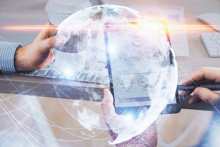 Double exposure of mans hands holding and using a phone and international business theme drawing.