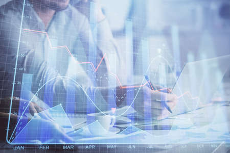 Multi exposure of man and woman working together and financial chart hologram. Business concept....