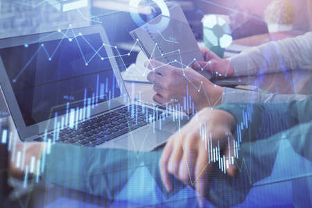 Double exposure of man and woman working together and forex chart hologram. Business concept....