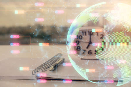 Multi exposure of world map drawings and desk with open notebook background. Concept of globolizationの写真素材