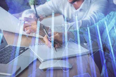 Double exposure of forex chart drawing over people taking notes background. Concept of financial...