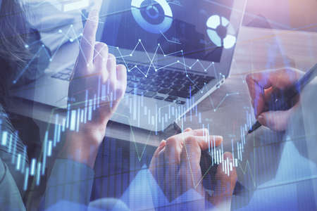 Double exposure of man and woman working together and forex chart hologram. Business concept....