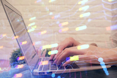 Double exposure of woman hands working on computer and data theme hologram drawing. Tech concept.の写真素材