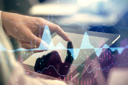 Multi exposure of mans hands holding and using a phone and financial chart drawing. Market analysis...