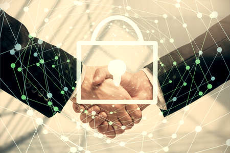 Double exposure of lock hologram and handshake of two men. Partnership security concept.