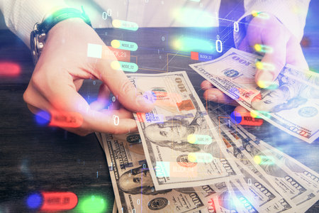Double exposure of technology drawing hologram and us dollars bills and man hands. Data conceptの写真素材
