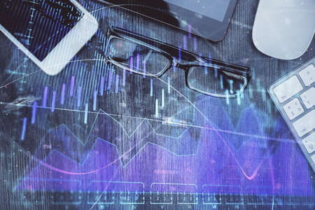 Multi exposure of forex graph hologram over desktop with phone. Top view. Mobile trade platform...