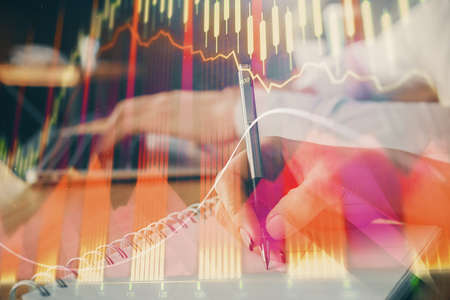 Double exposure of forex chart drawing over people taking notes background. Concept of financial analysisの写真素材