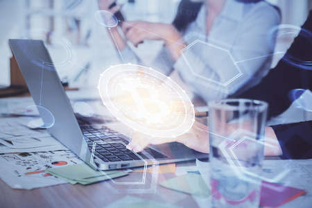 Double exposure of woman hands typing on computer and crypto market theme hologram drawing. Blockchain concept.の写真素材