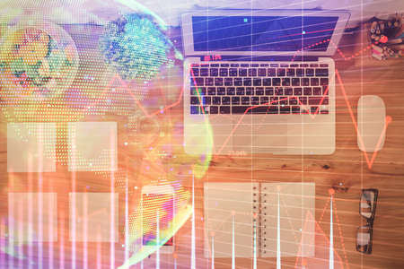 Stock market graph and top view computer on the table background. Multi exposure. Concept of...