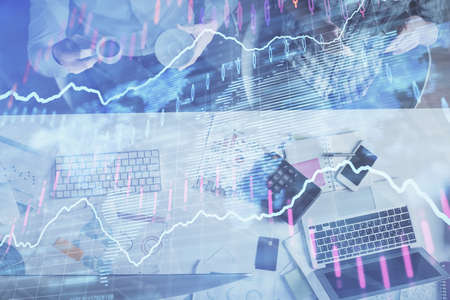 Double exposure of man and woman working together and financial chart hologram drawing. market...