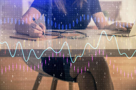 Double exposure of businesswoman hands typing on computer and forex chart hologram drawing....