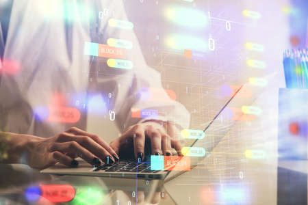 Double exposure of woman hands working on computer and data theme hologram drawing. Tech concept.
