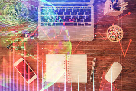 Stock market graph and top view computer on the table background. Multi exposure. Concept of...