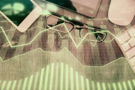 Multi exposure of forex graph hologram over desktop with phone. Top view. Mobile trade platform concept.の写真素材