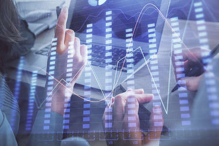 Double exposure of man and woman working together and forex chart hologram. Business concept....