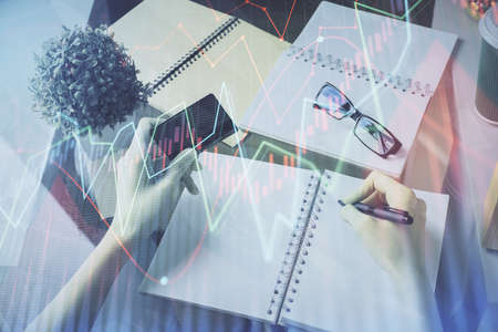 Multi exposure of woman on-line shopping holding a credit card and financial graph drawing. Stock...