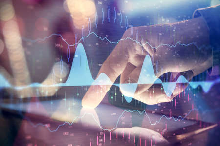 Multi exposure of mans hands holding and using a phone and financial chart drawing. Market analysis...