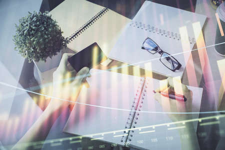 Multi exposure of woman on-line shopping holding a credit card and financial graph drawing. Stock market E-commerce concept.の写真素材