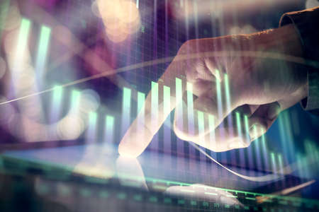 Multi exposure of mans hands holding and using a phone and financial chart drawing. Market analysis...