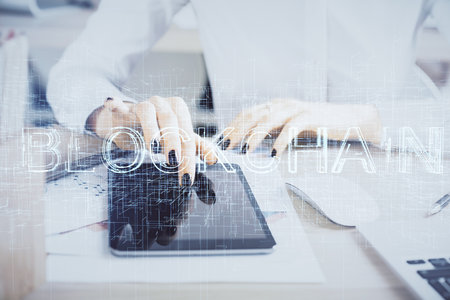 Double exposure of blockchain business sketch hologram and woman holding and using a mobile device.