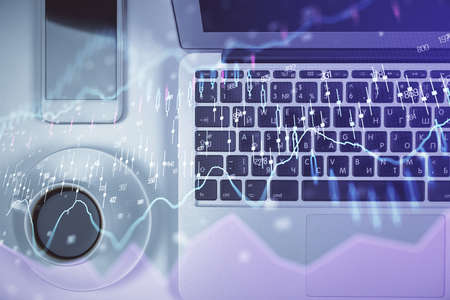 Stock market chart and top view computer on the table background. Multi exposure. Concept of...