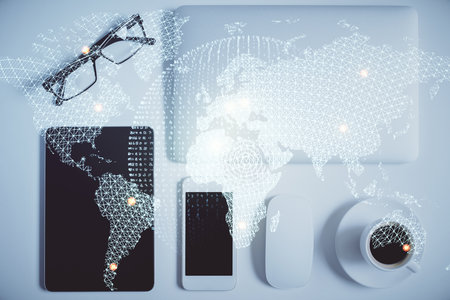 Double exposure of business theme hologram over desktop with phone. Top view. Mobile international...