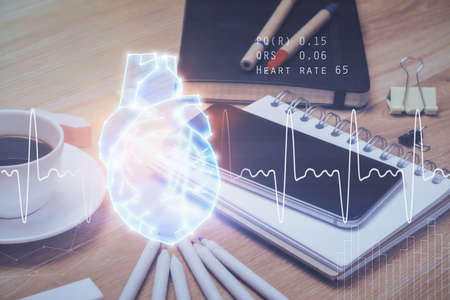 Double exposure of human heart drawing and cell phone background. Concept of medical education