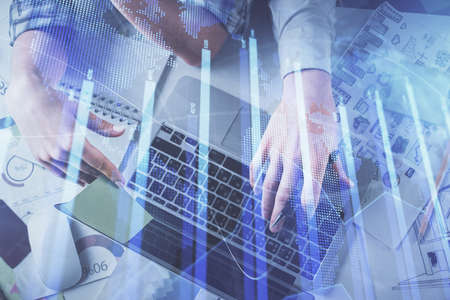 Double exposure of man and woman working together and forex graph hologram drawing. Financial...