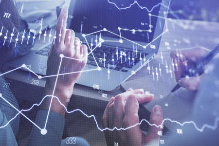 Double exposure of man and woman working together and forex chart hologram. Business concept....