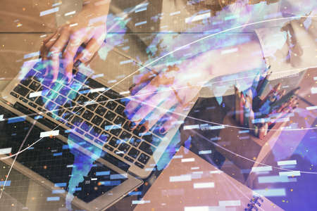 Double exposure of woman hands working on computer and data theme hologram drawing. Tech concept.の写真素材