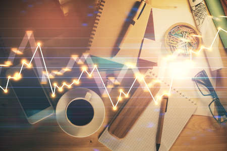 Double exposure of forex graph drawing and work table top veiw. Concept of financial analysis.