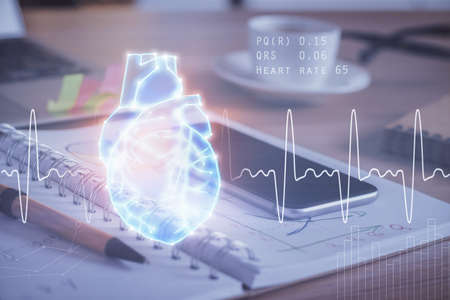 Double exposure of human heart drawing and cell phone background. Concept of medical education