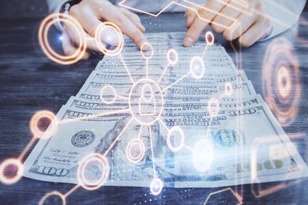Multi exposure of social network theme drawing hologram and USA dollars bills and man hands.