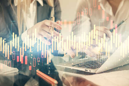 Double exposure of man and woman working together and forex chart hologram. Business concept....