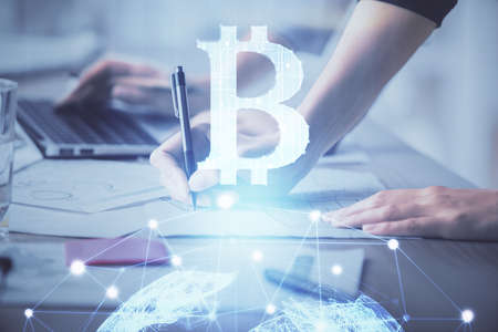 Double exposure of woman hands typing on computer and crypto market theme hologram drawing....