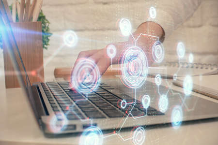 Double exposure of woman hands working on computer and data theme hologram drawing. Tech concept.