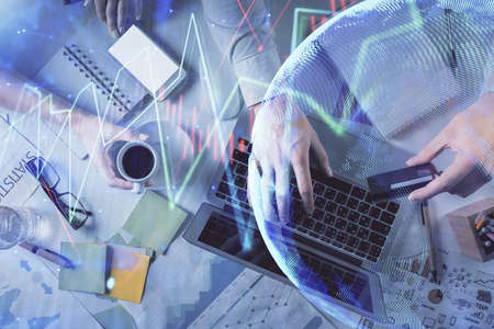 Double exposure of man and woman working together and forex graph hologram drawing. Financial...