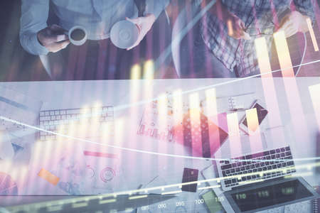 Double exposure of man and woman working together and financial chart hologram drawing. market...