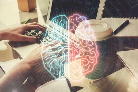 Double exposure of woman hands working on computer and brain hologram drawing. Ai concept.