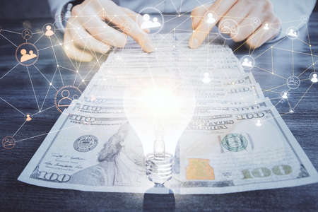Multi exposure of social network theme drawing hologram and USA dollars bills and man hands.