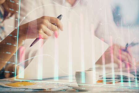 Double exposure of forex graph drawing over people taking notes background. Concept of financial...