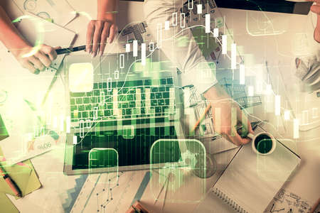 Double exposure of man and woman working together and financial graph hologram. Business concept. Computer background.の写真素材